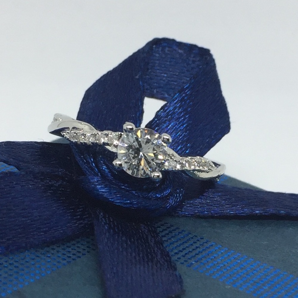 Twisted sparkling terling solitaire promise ring